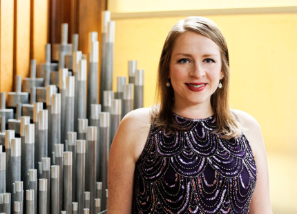 Amanda Mole poses in front of organ. 